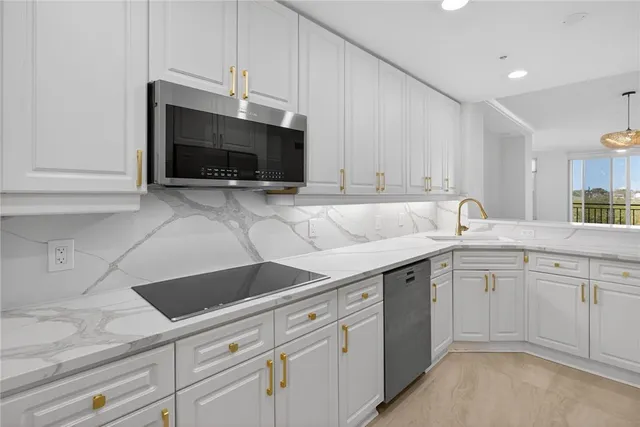 a view of a kitchen with white cabinets