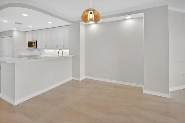an empty room with a empty space and windows