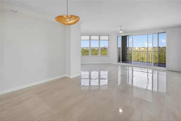 a view of an empty room with window and cabinet