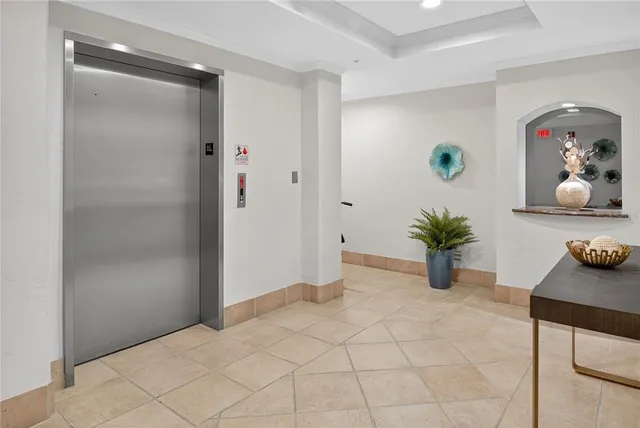 a view of a livingroom with furniture and a potted plant