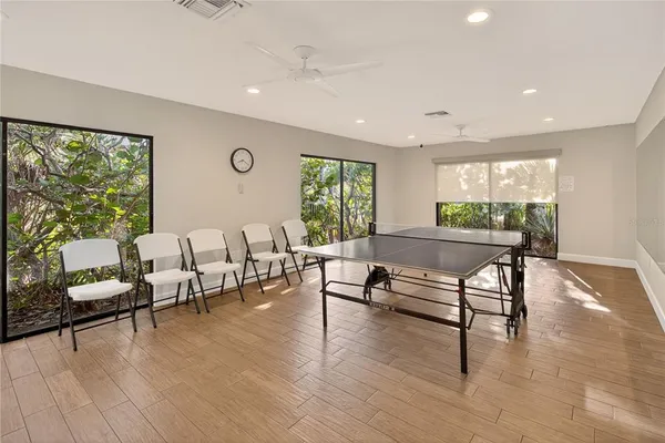 a view of a big room with furniture and a large window
