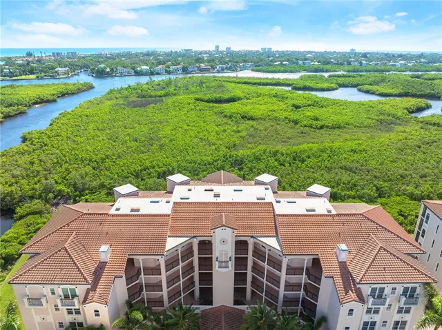an aerial view of multiple houses with yard