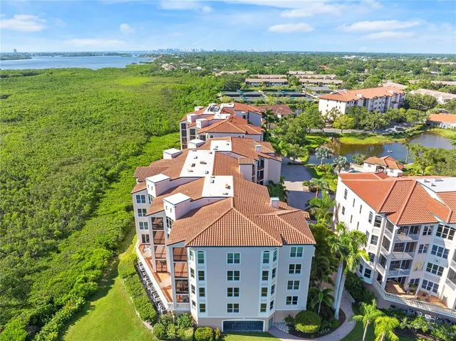 an aerial view of residential houses with outdoor space and swimming pool