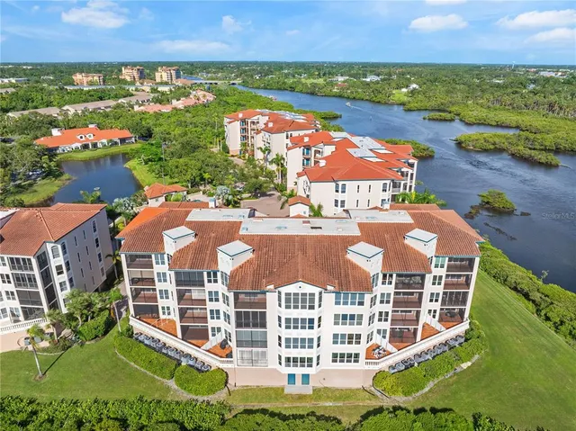 an aerial view of residential houses with outdoor space and lake view