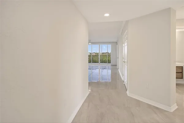 a view of hallway with bathroom