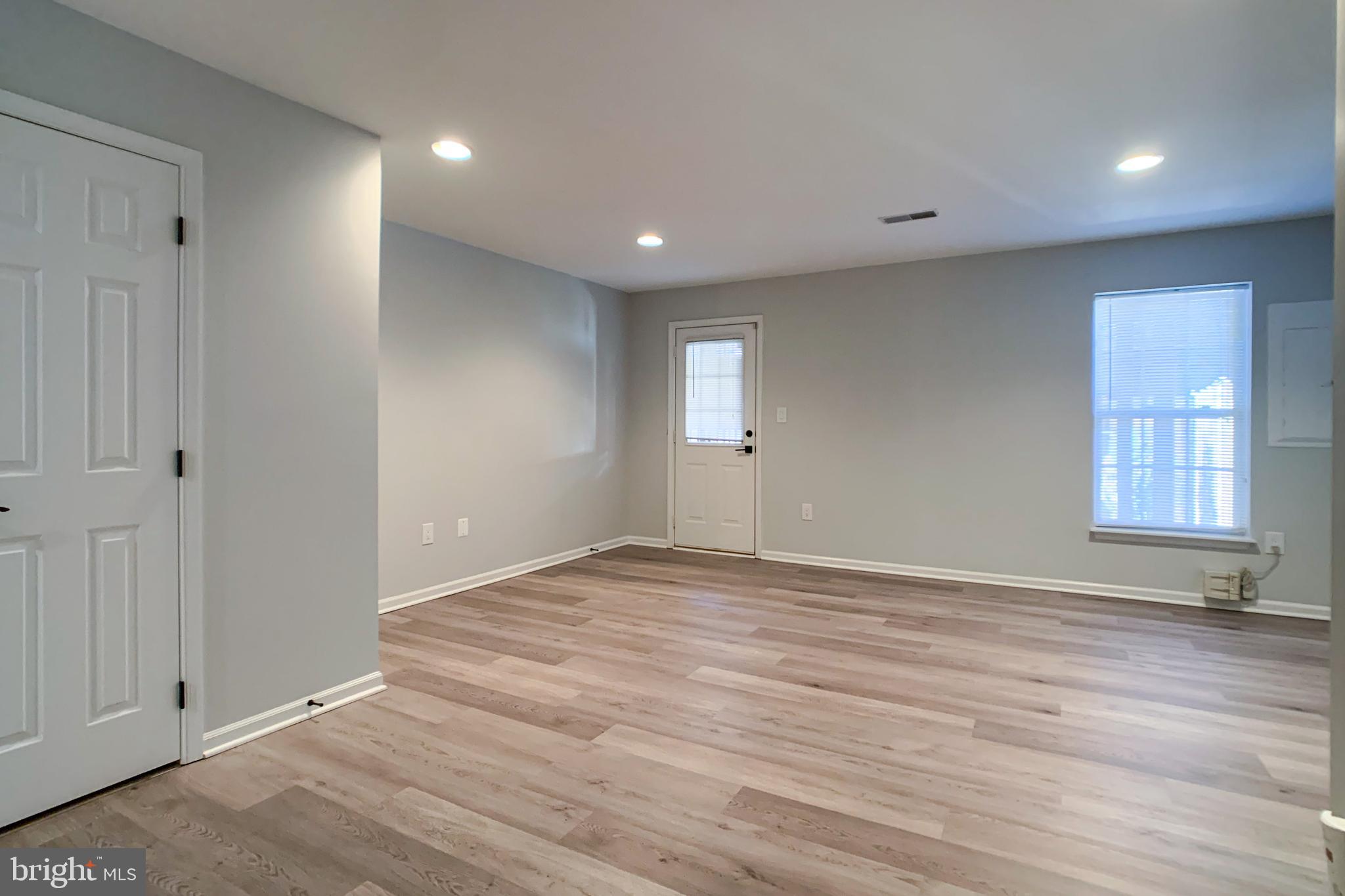 6988 Cromarty Drive Alexandria, VA 22315 - Photo 13 of 62 a view of an empty room with window and wooden floor