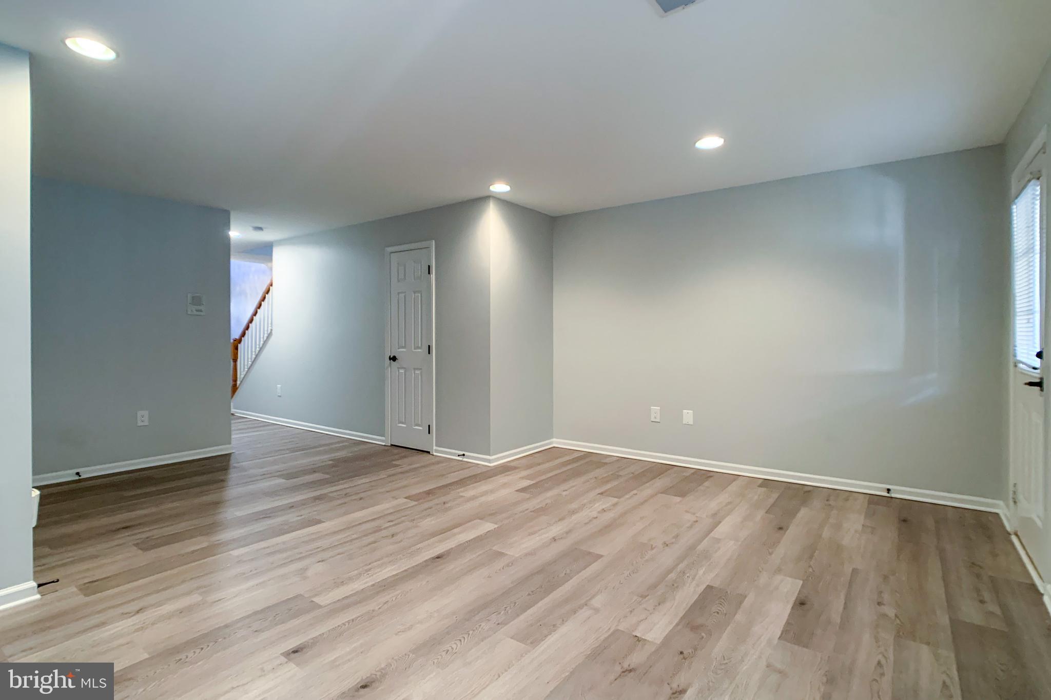 6988 Cromarty Drive Alexandria, VA 22315 - Photo 14 of 62 an empty room with wooden floor and windows
