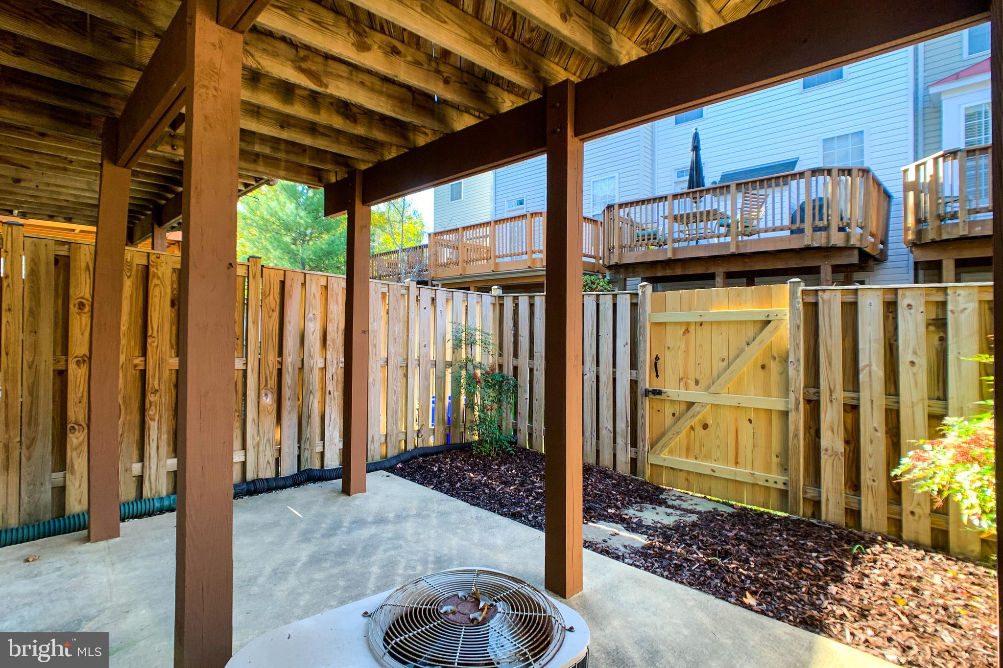 6988 Cromarty Drive Alexandria, VA 22315 - Photo 17 of 62 a view of a porch with a table and chairs and potted plants