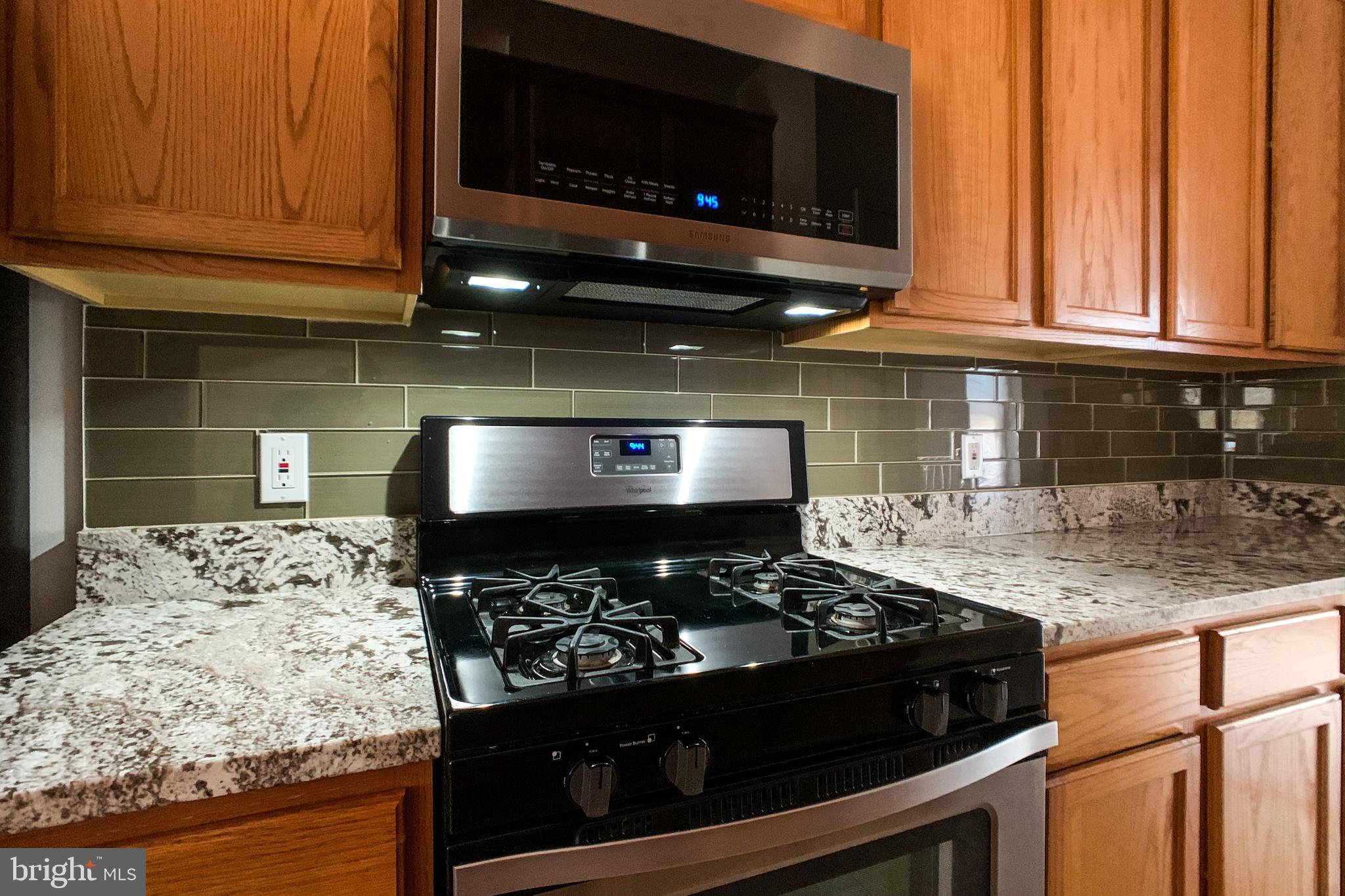 6988 Cromarty Drive Alexandria, VA 22315 - Photo 27 of 62 a kitchen with a stove and a microwave