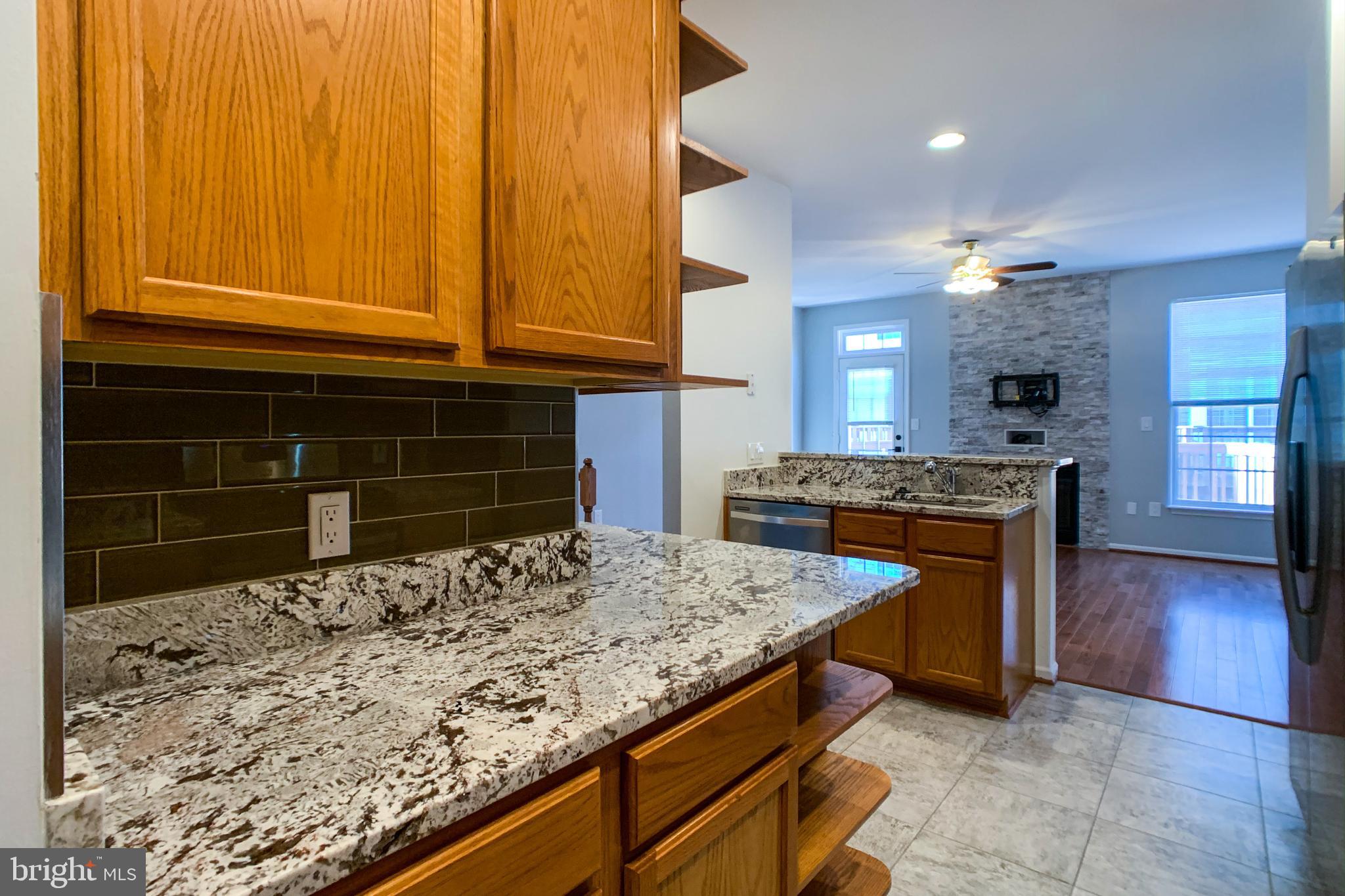 6988 Cromarty Drive Alexandria, VA 22315 - Photo 29 of 62 a kitchen with a stove and a wooden cabinets