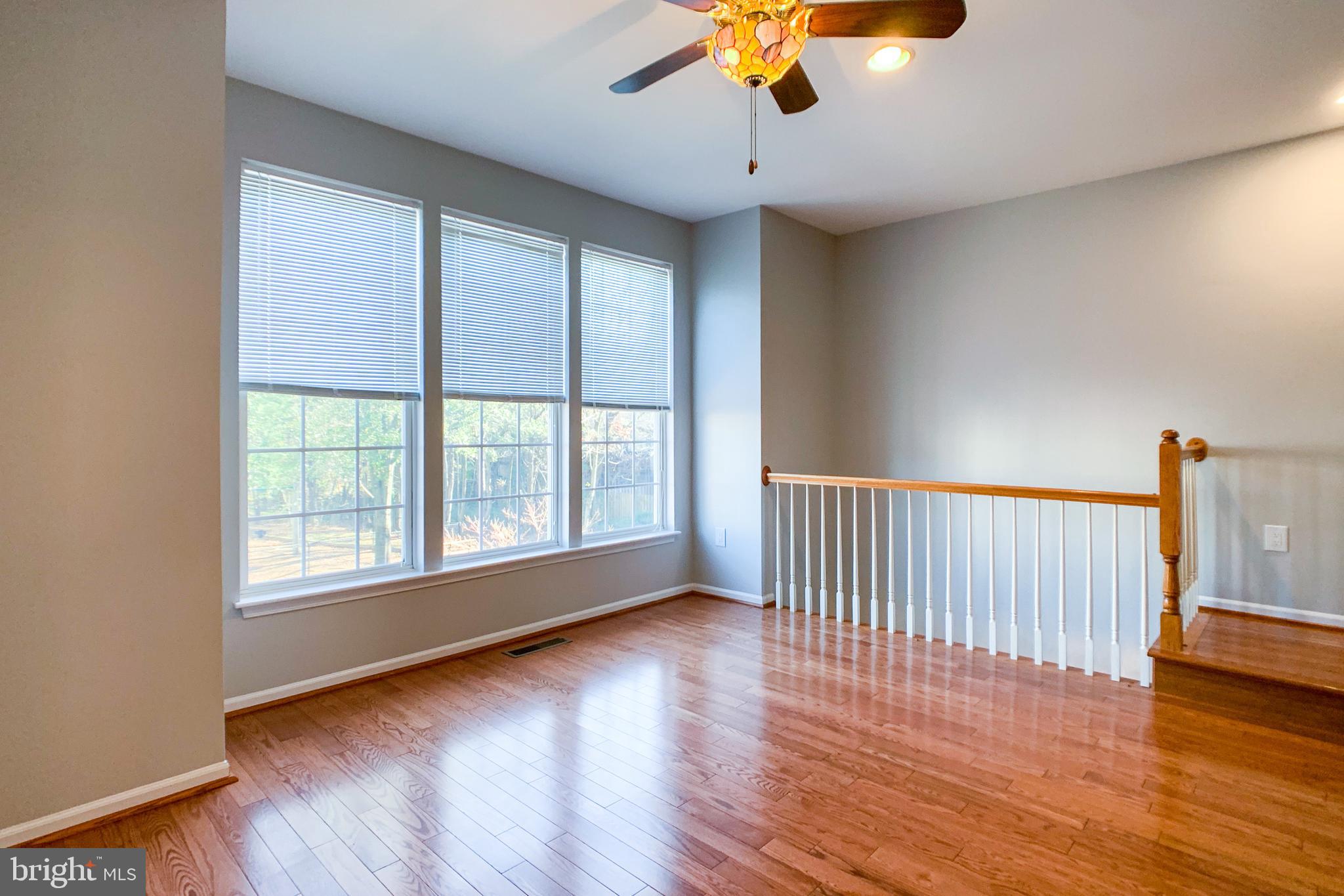 6988 Cromarty Drive Alexandria, VA 22315 - Photo 31 of 62 a view of an empty room with wooden floor and a window