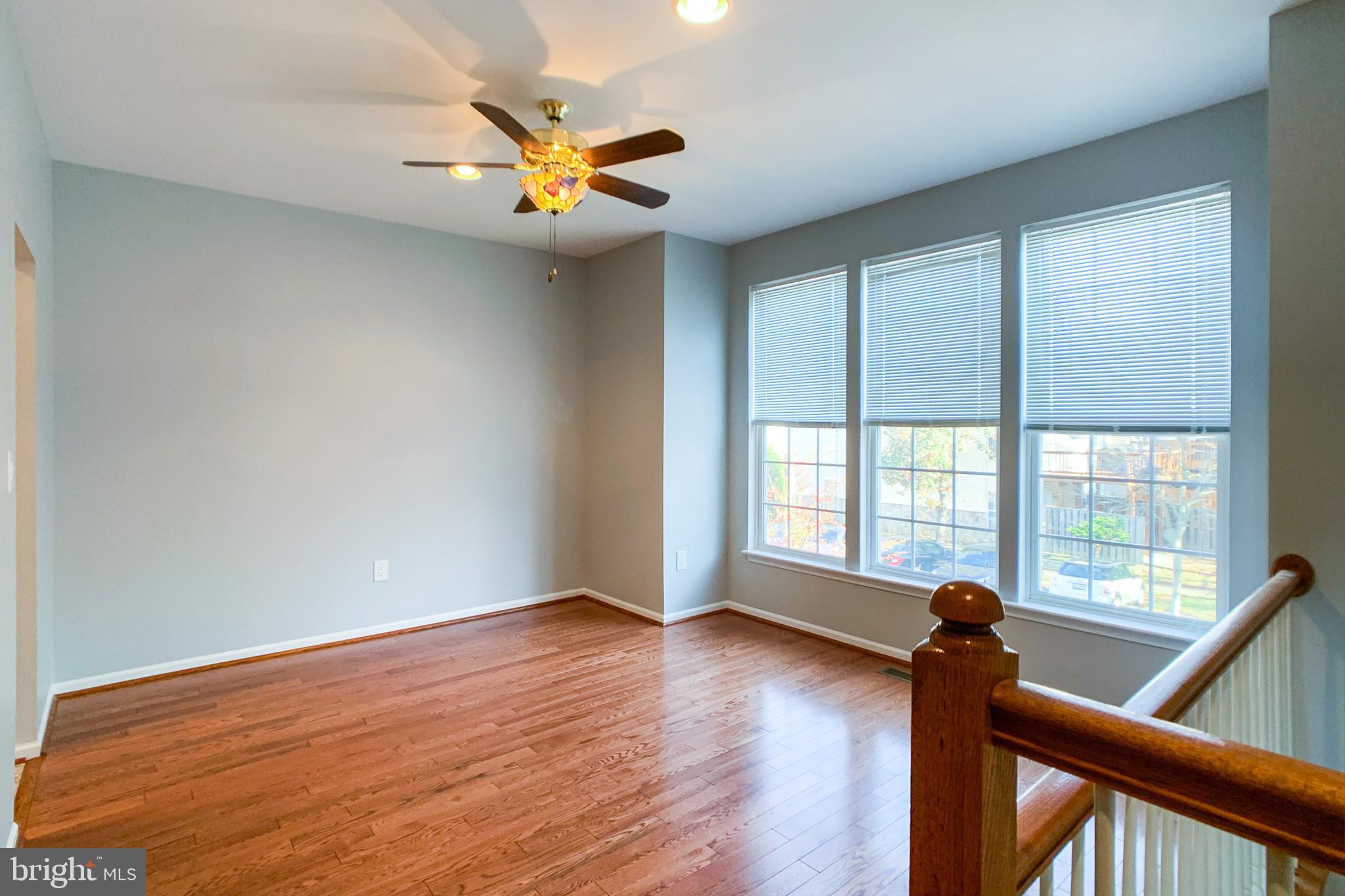 6988 Cromarty Drive Alexandria, VA 22315 - Photo 33 of 62 a view of a livingroom with a ceiling fan and wooden floor