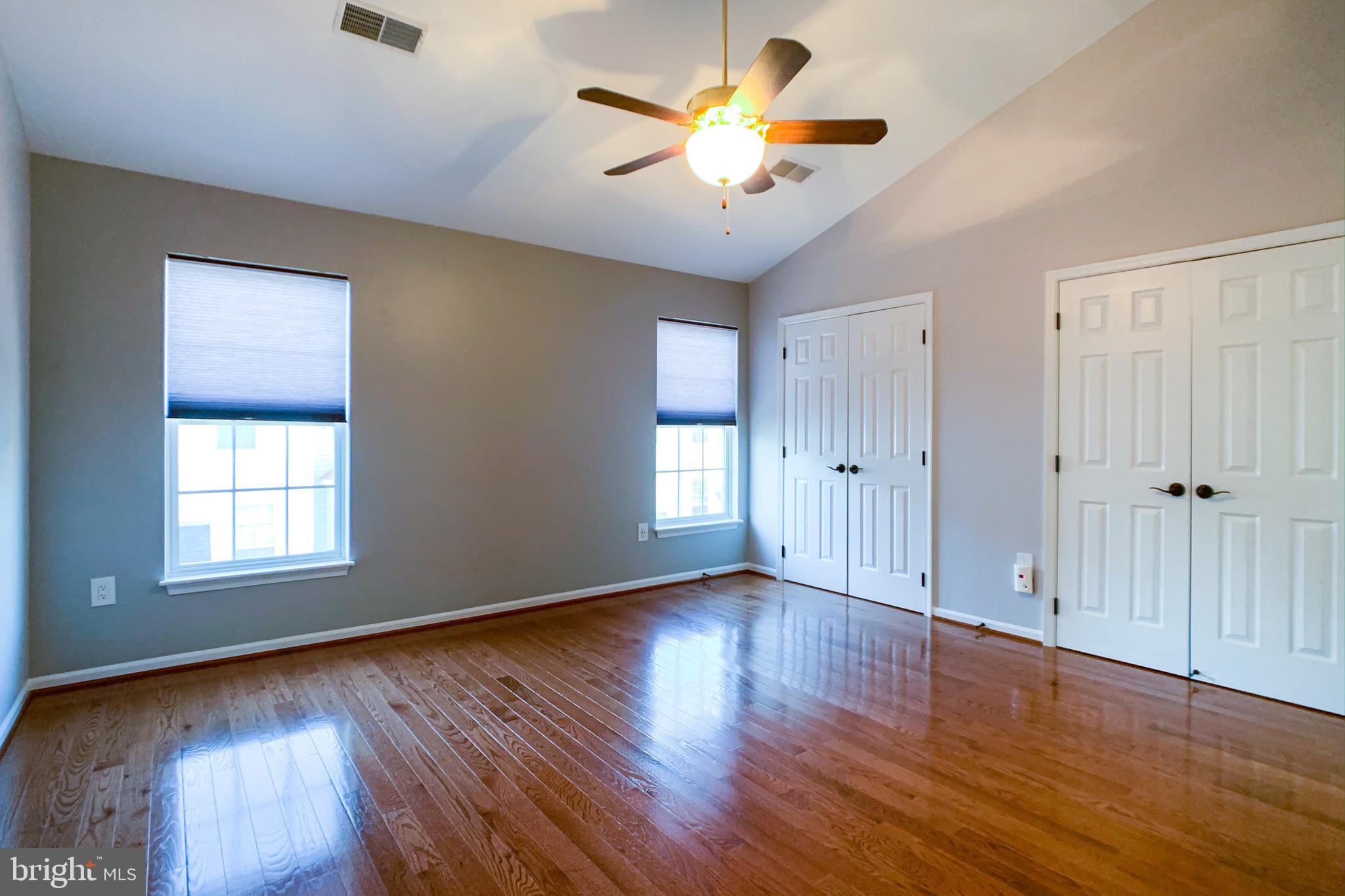 6988 Cromarty Drive Alexandria, VA 22315 - Photo 38 of 62 a view of an empty room with window and wooden floor