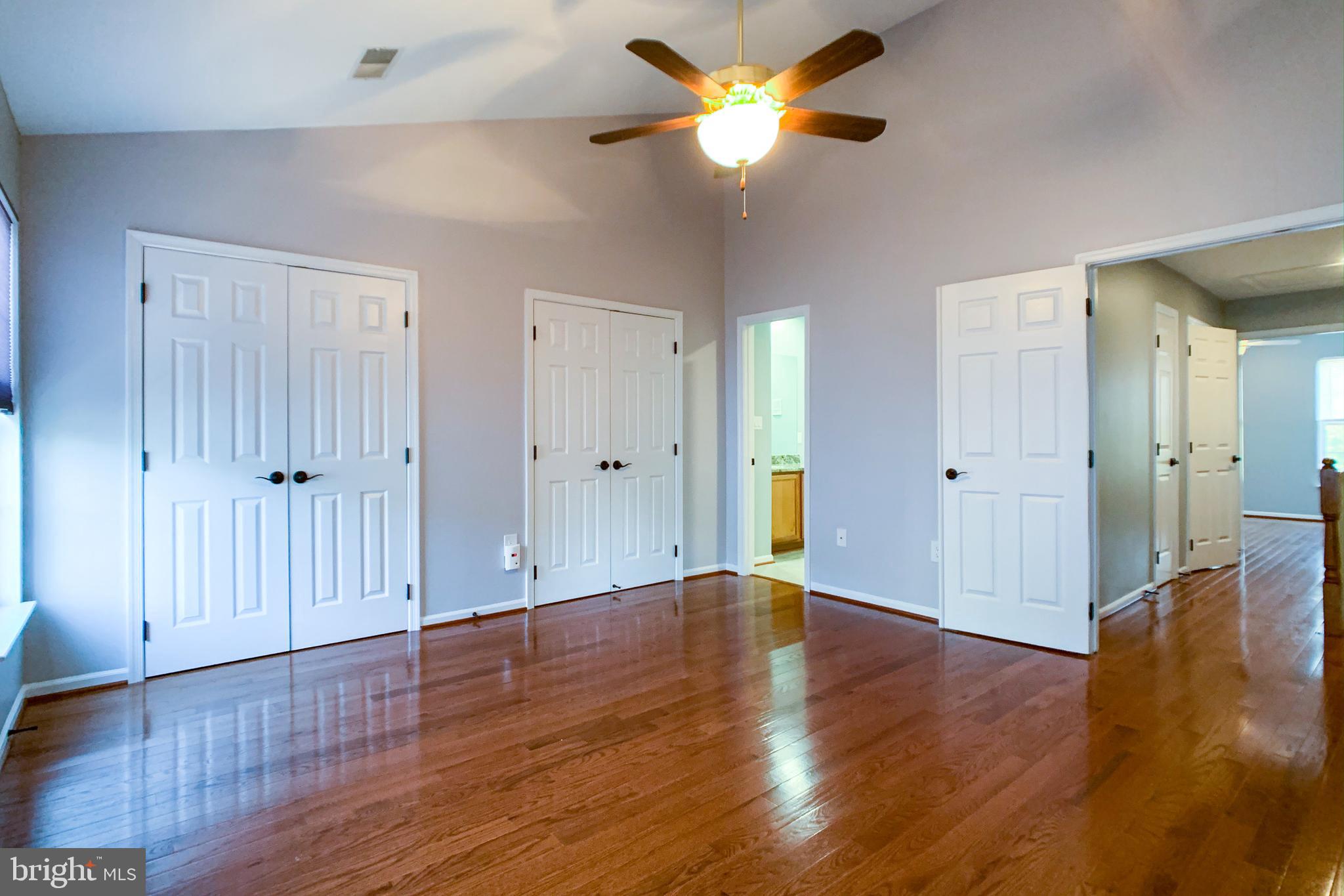 6988 Cromarty Drive Alexandria, VA 22315 - Photo 39 of 62 an empty room with wooden floor and a ceiling fan