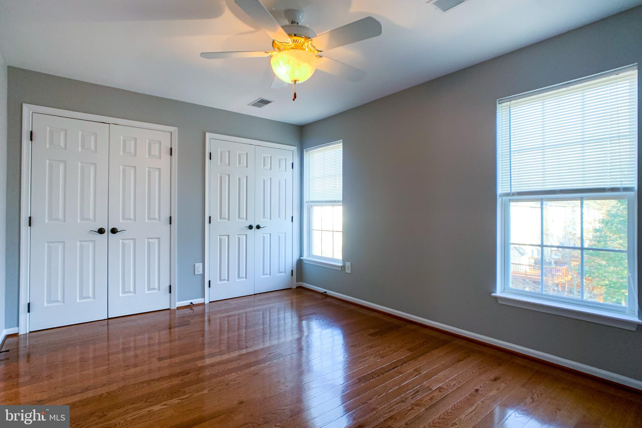 6988 Cromarty Drive Alexandria, VA 22315 - Photo 46 of 62 an empty room with wooden floor and windows