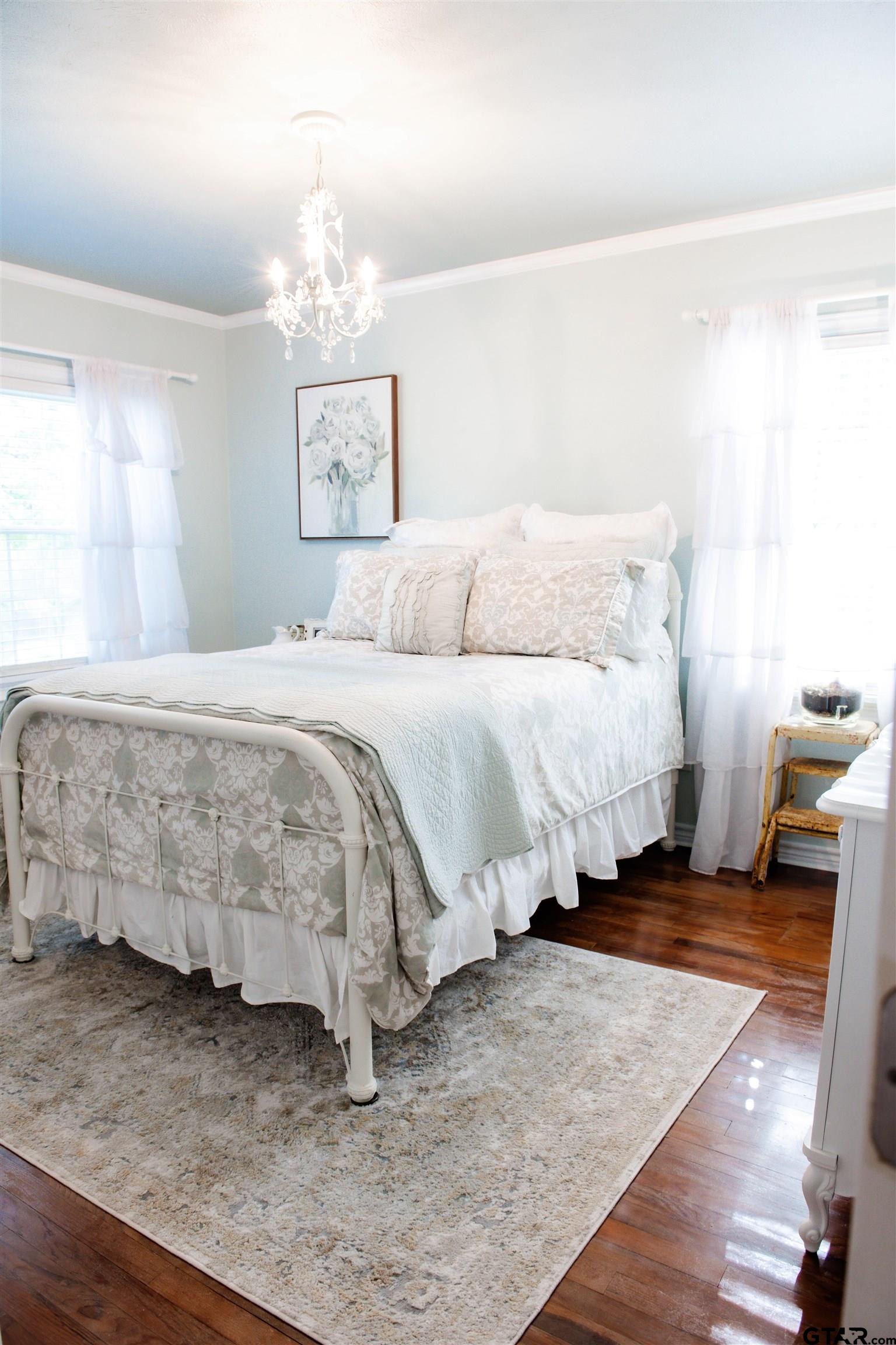 265 Hatchett Street Rusk, TX 75785 - Photo 5 of 17 a bedroom with a bed and a chandelier