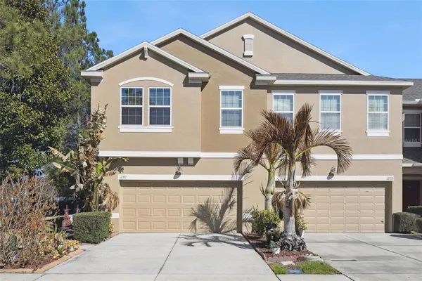 a front view of a house with a yard and garage