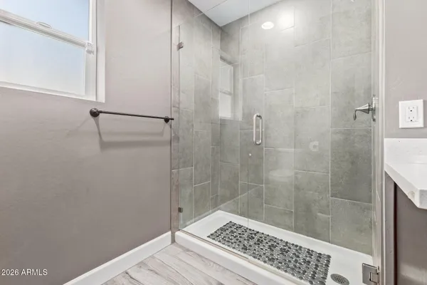 a bathroom with a bathtub shower sink mirror and toilet