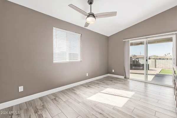 a kitchen with stainless steel appliances kitchen island granite countertop a refrigerator a sink a stove and a wooden floors