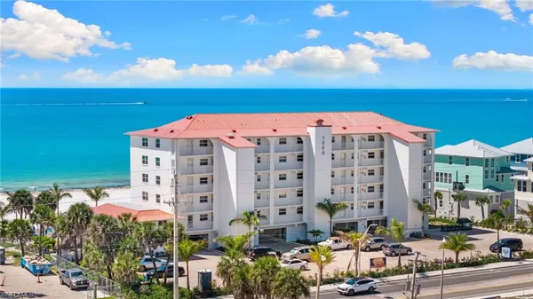 a view of building with outdoor space and ocean view