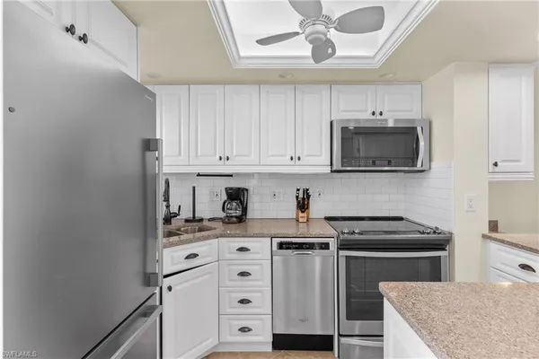 a kitchen with stainless steel appliances a stove microwave and cabinets