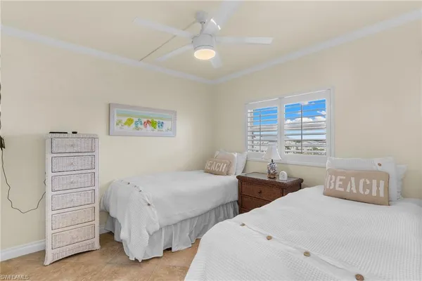 a bedroom with two beds and a chandelier