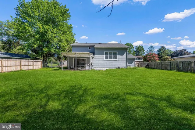 a view of a house with a yard and sitting area