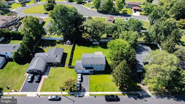 an aerial view of a swimming pool with outdoor seating