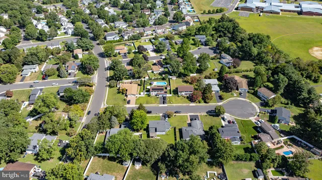 an aerial view of a house with yard swimming pool and outdoor seating