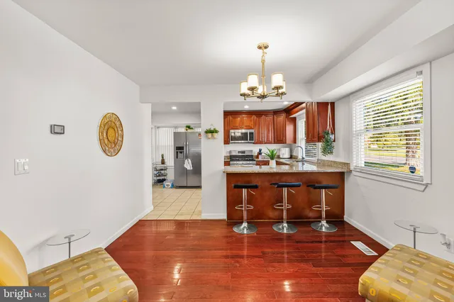 a view of kitchen with dining table and chandelier