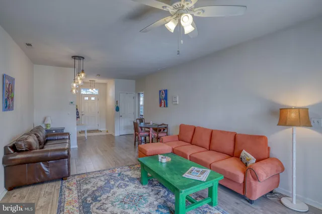 a living room with furniture a table and a chandelier