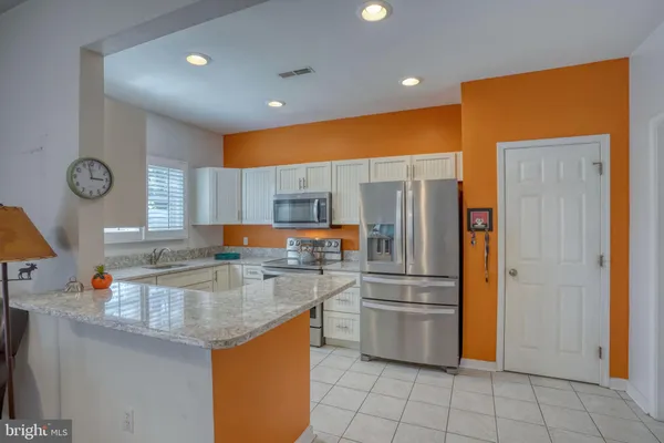 a living room with furniture and a kitchen