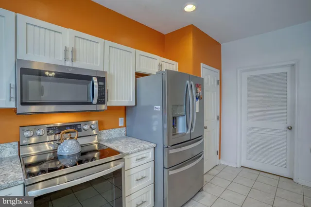 a kitchen that has a sink and a stove in it