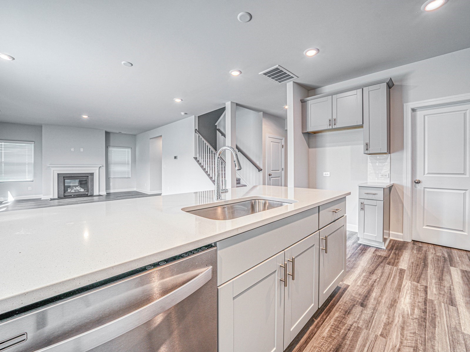 3741 Lantern Lane Murfreesboro, TN 37128 - Photo 7 of 19 a kitchen with a sink dishwasher and white cabinets with wooden floor