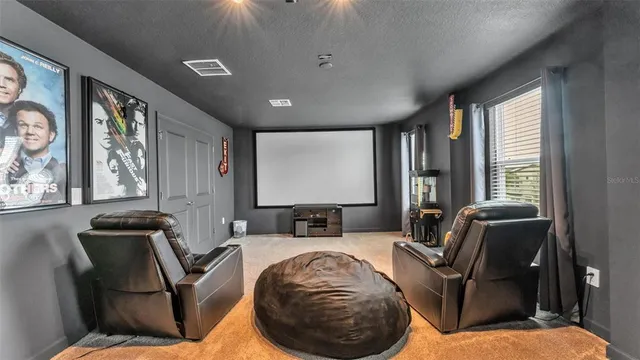 an aerial view of residential houses with outdoor space and seating area