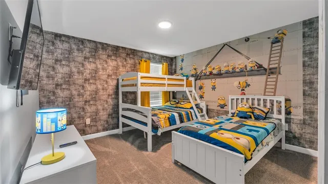 a bedroom with two beds and painting on the wall