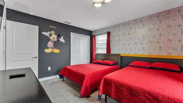 a bedroom with a bed and a flat screen tv