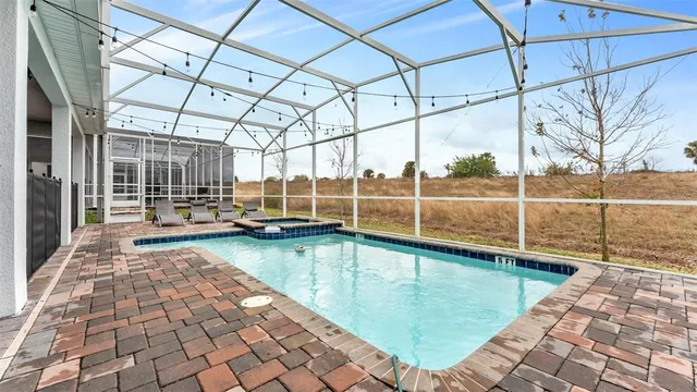 a en suite bathroom with a granite countertop sink and a mirror