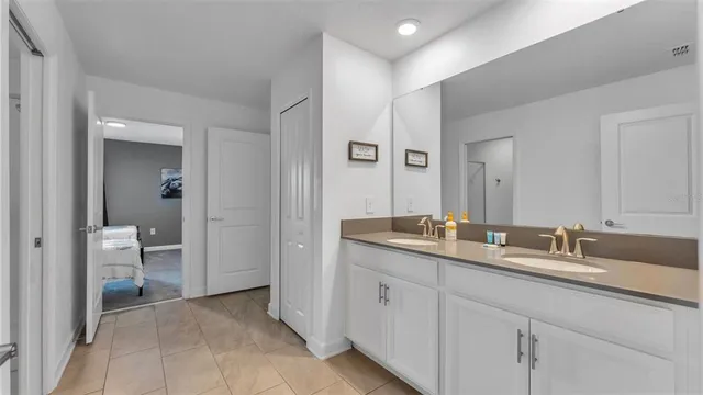 a bathroom with a granite countertop toilet a sink and a mirror