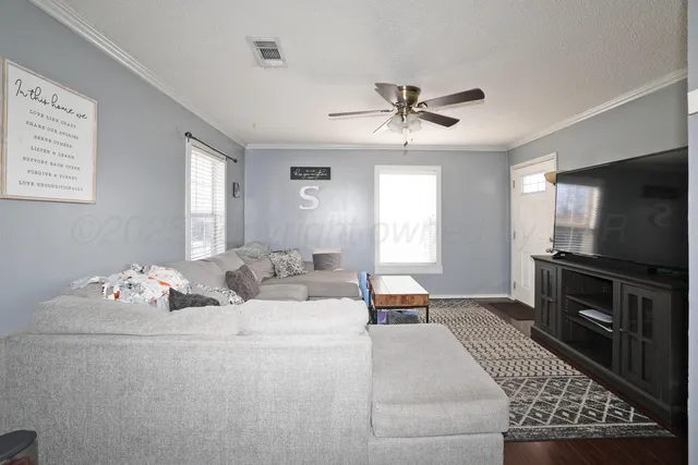 a living room with furniture and a flat screen tv