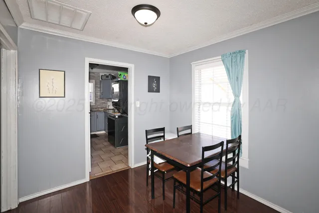 a view of a dining room with furniture and wooden floor