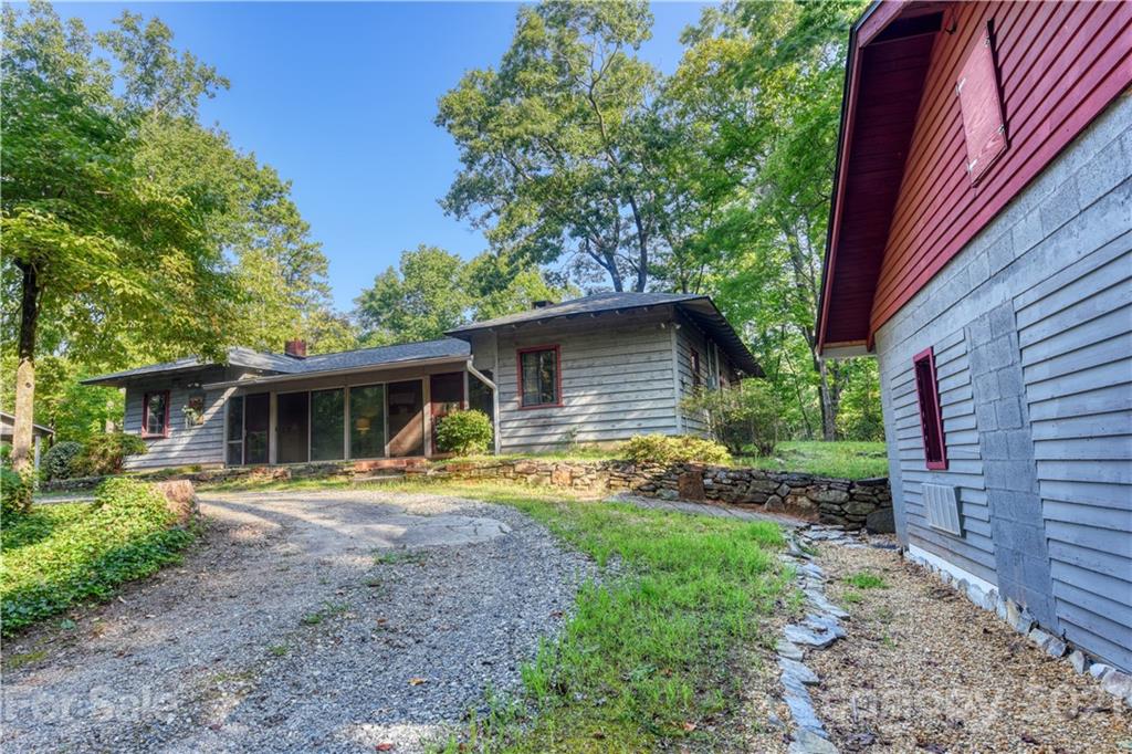 528 Wilderness Road Tryon, NC 28782 - Photo 1 of 29 a view of a house with backyard and trees