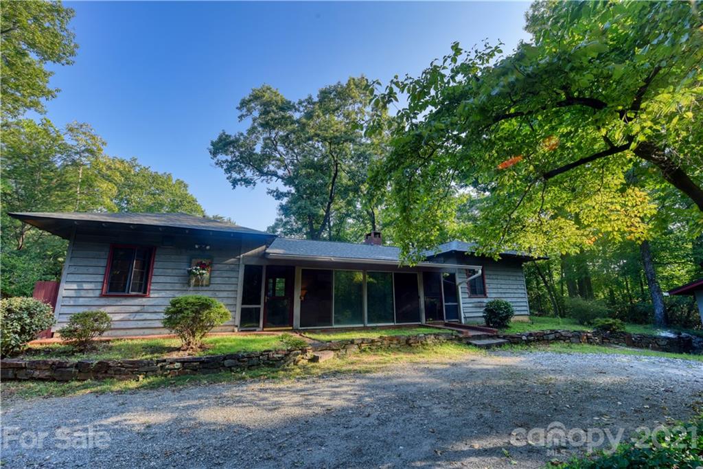 528 Wilderness Road Tryon, NC 28782 - Photo 2 of 29 a view of a house with pool and a large tree
