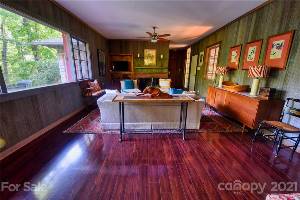 528 Wilderness Road Tryon, NC 28782 - Photo 15 of 29 a living room with furniture a large window and wooden floor