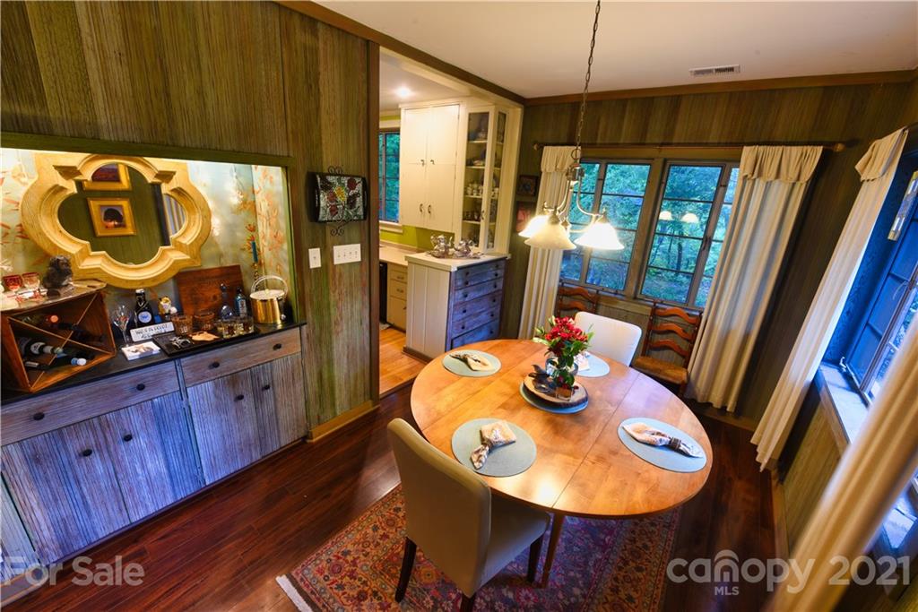 528 Wilderness Road Tryon, NC 28782 - Photo 16 of 29 a view of a dining room with furniture window and wooden floor