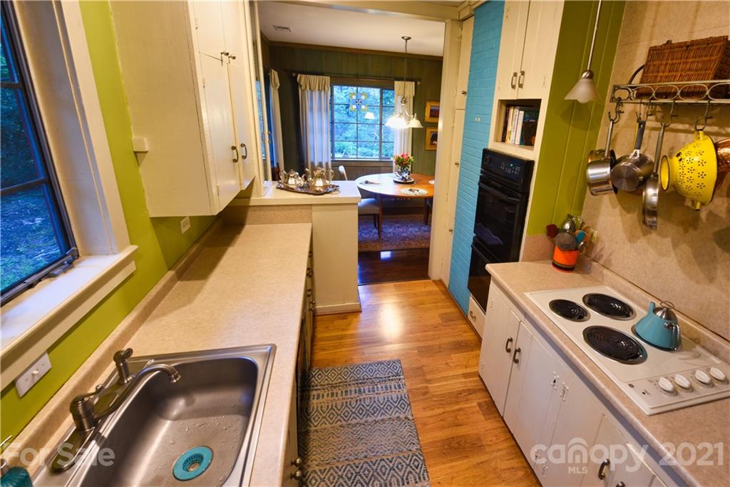 528 Wilderness Road Tryon, NC 28782 - Photo 18 of 29 a kitchen with a sink stove and refrigerator
