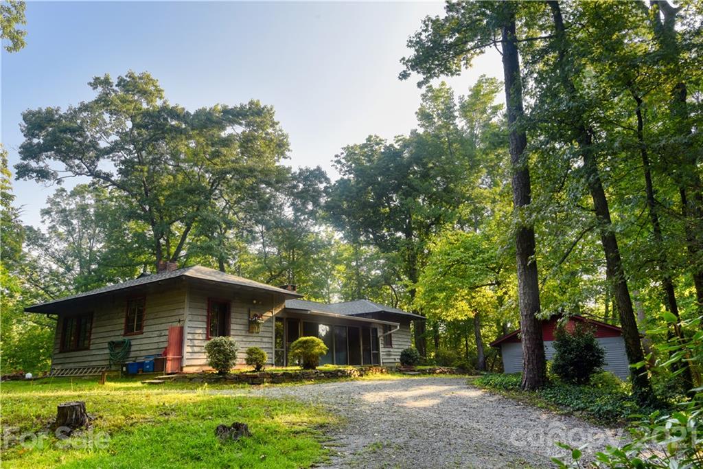 528 Wilderness Road Tryon, NC 28782 - Photo 3 of 29 a front view of a house with garden