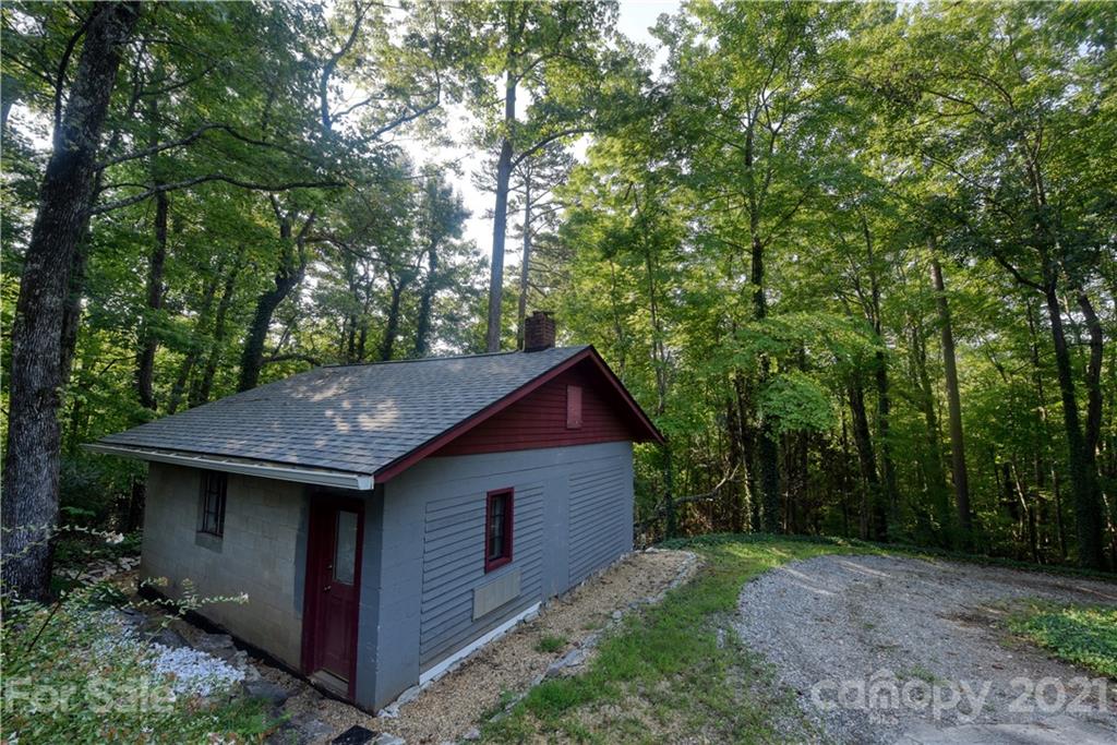528 Wilderness Road Tryon, NC 28782 - Photo 23 of 29 a backyard of a house with lots of green space