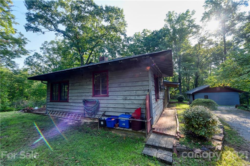 528 Wilderness Road Tryon, NC 28782 - Photo 4 of 29 a view of backyard with deck and outdoor seating