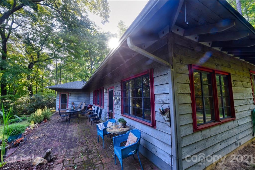 528 Wilderness Road Tryon, NC 28782 - Photo 6 of 29 a view of patio with a table and chairs and potted plants